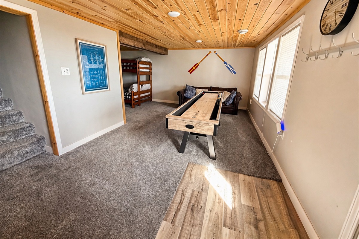As you come downstairs, you'll find the shuffleboard ready for some fun.. The walkout door leads straight to the backyard, giving you easy access to the fire pit area for evenings outdoors.