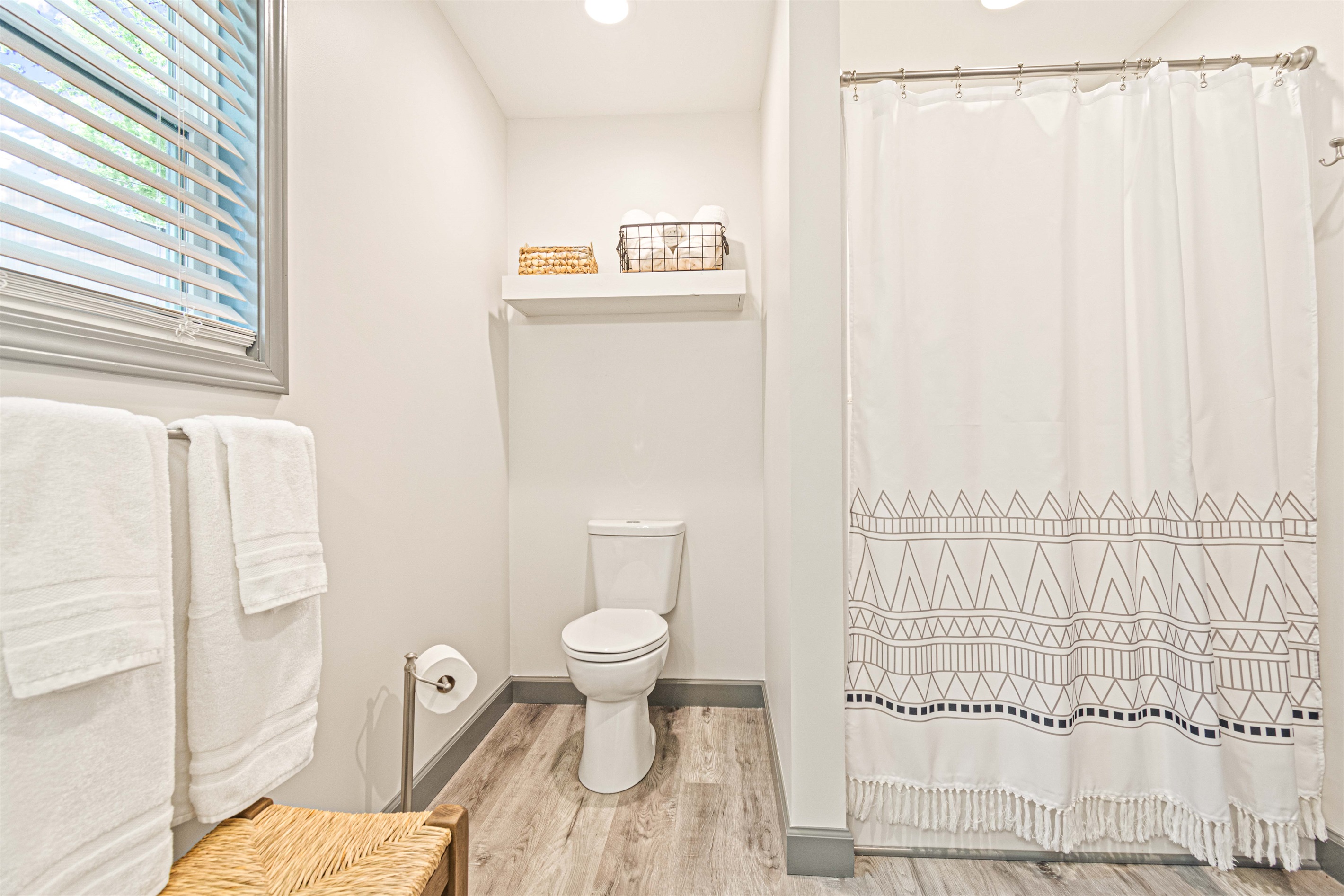 The downstairs master bathroom has a new seated shower.