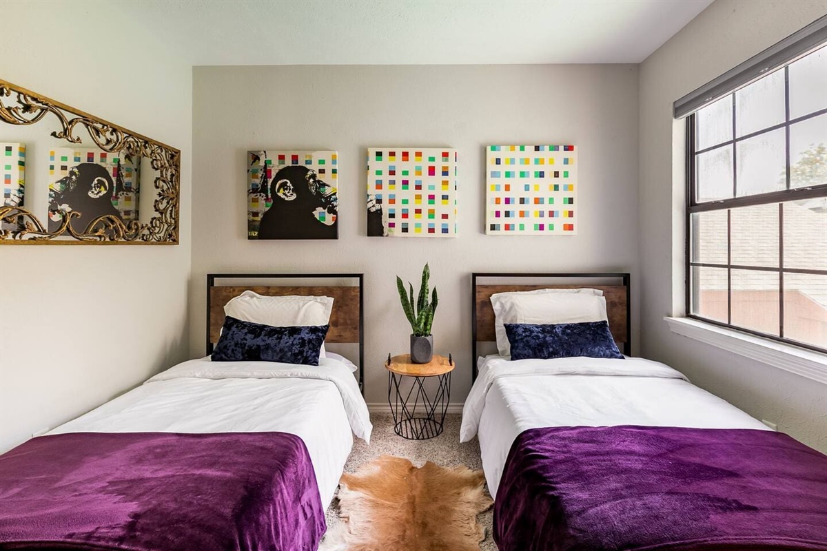 Guest room with twin beds and plenty of natural light.