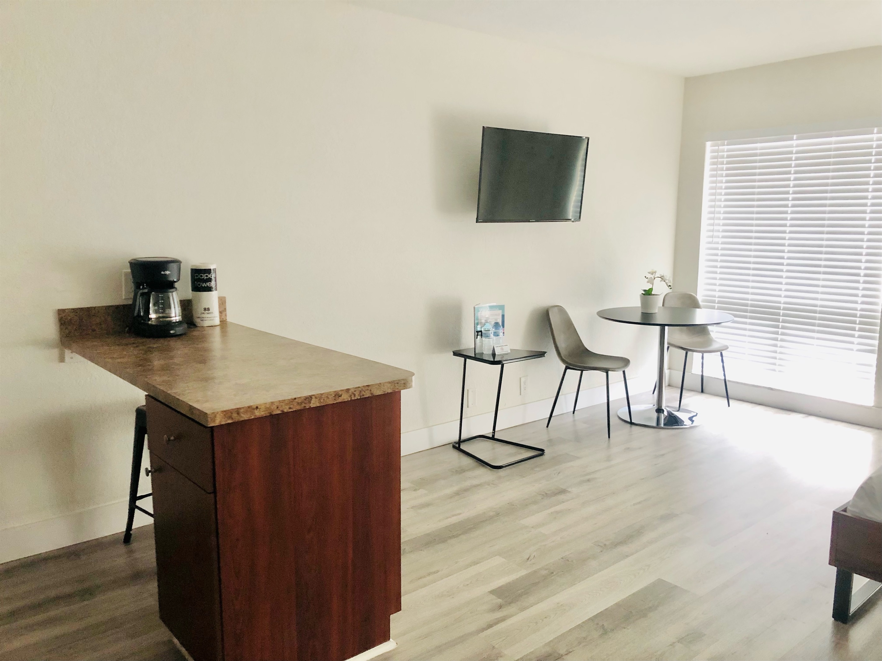 Featuring dining table, counter, smart TV and floor to ceiling windows.