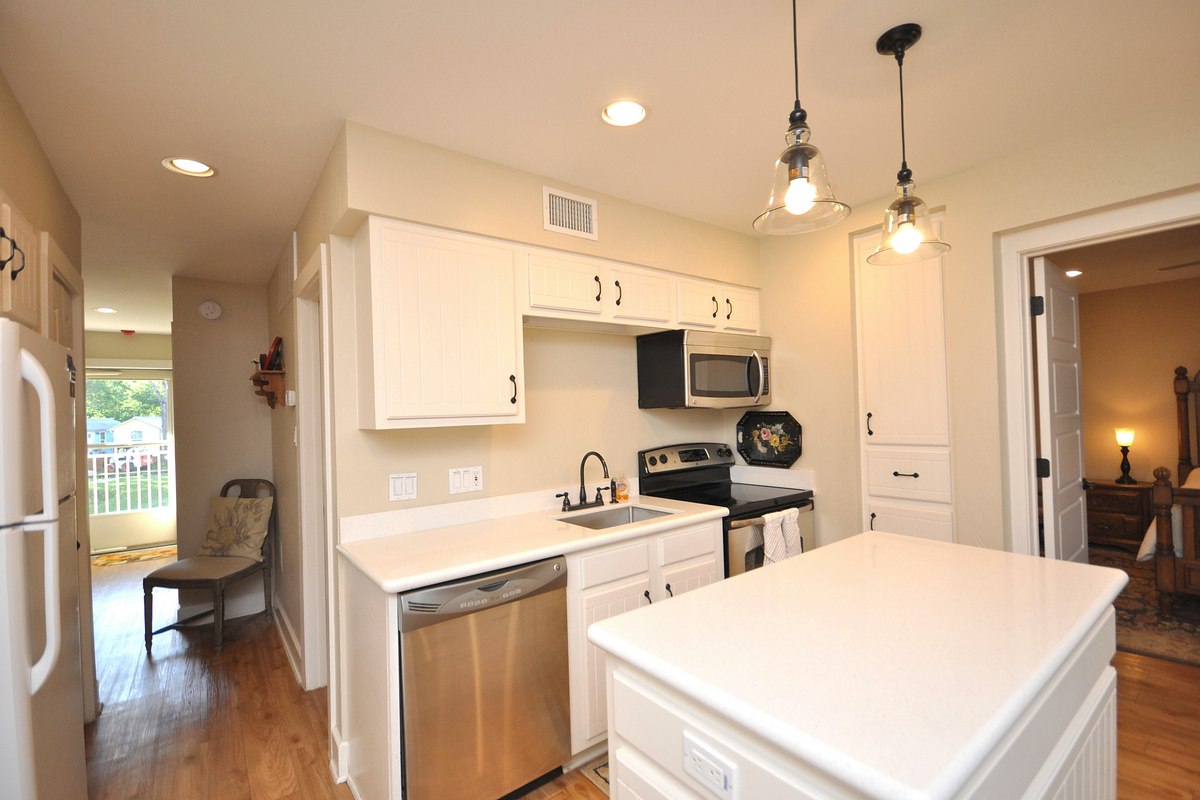 Cabinet next to stove and microwave is a small pantry.