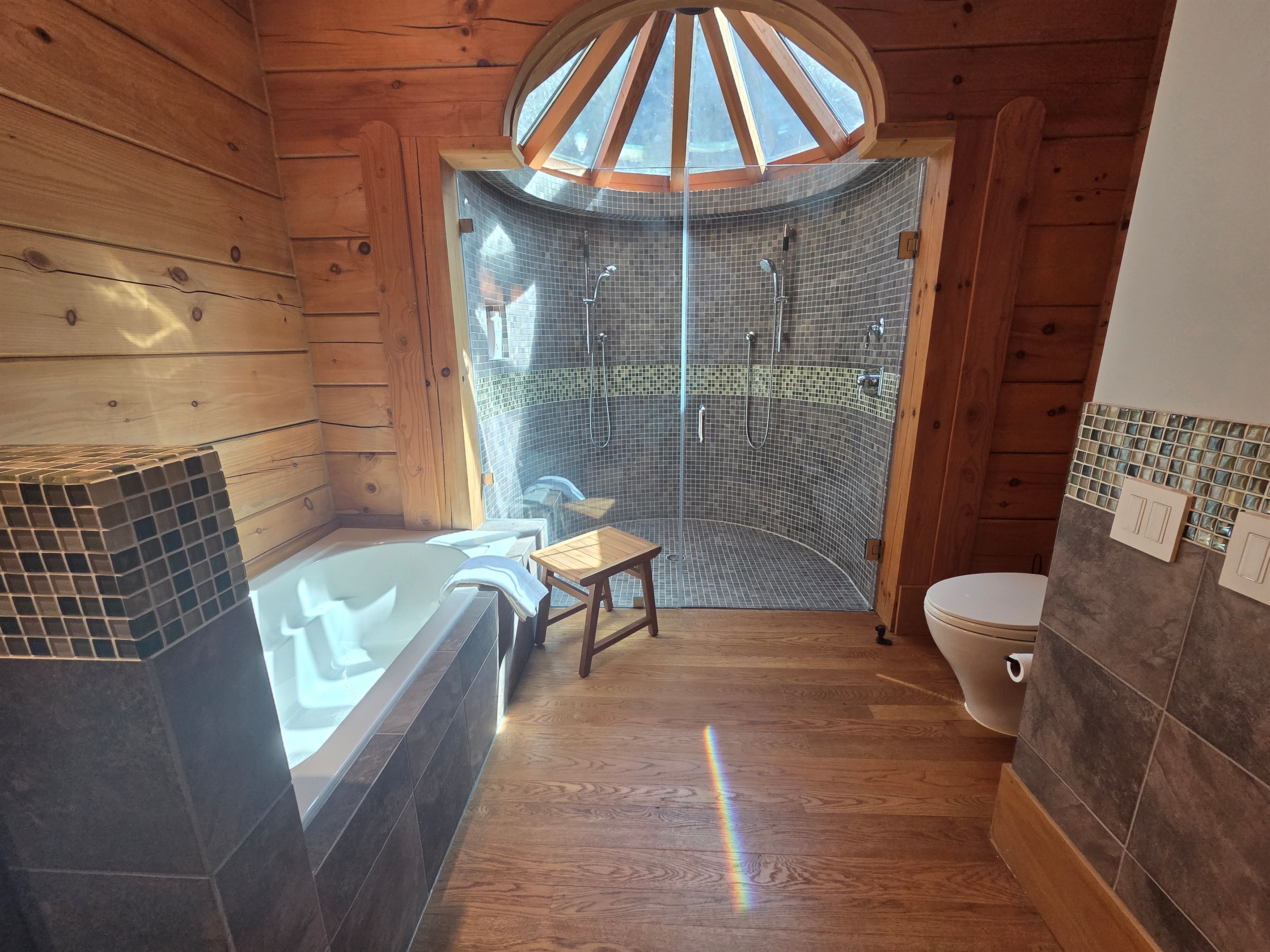 Spa-like second bedroom bathroom with a soaking tub and a large walk-in shower.