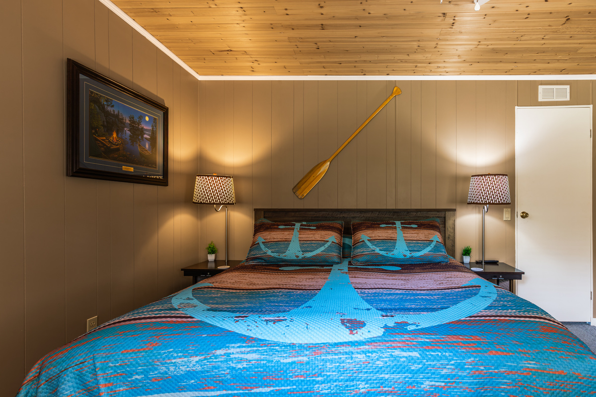 Unwind in the lake-inspired king bedroom with warm lighting, bedside tables, and plenty of room to settle in.