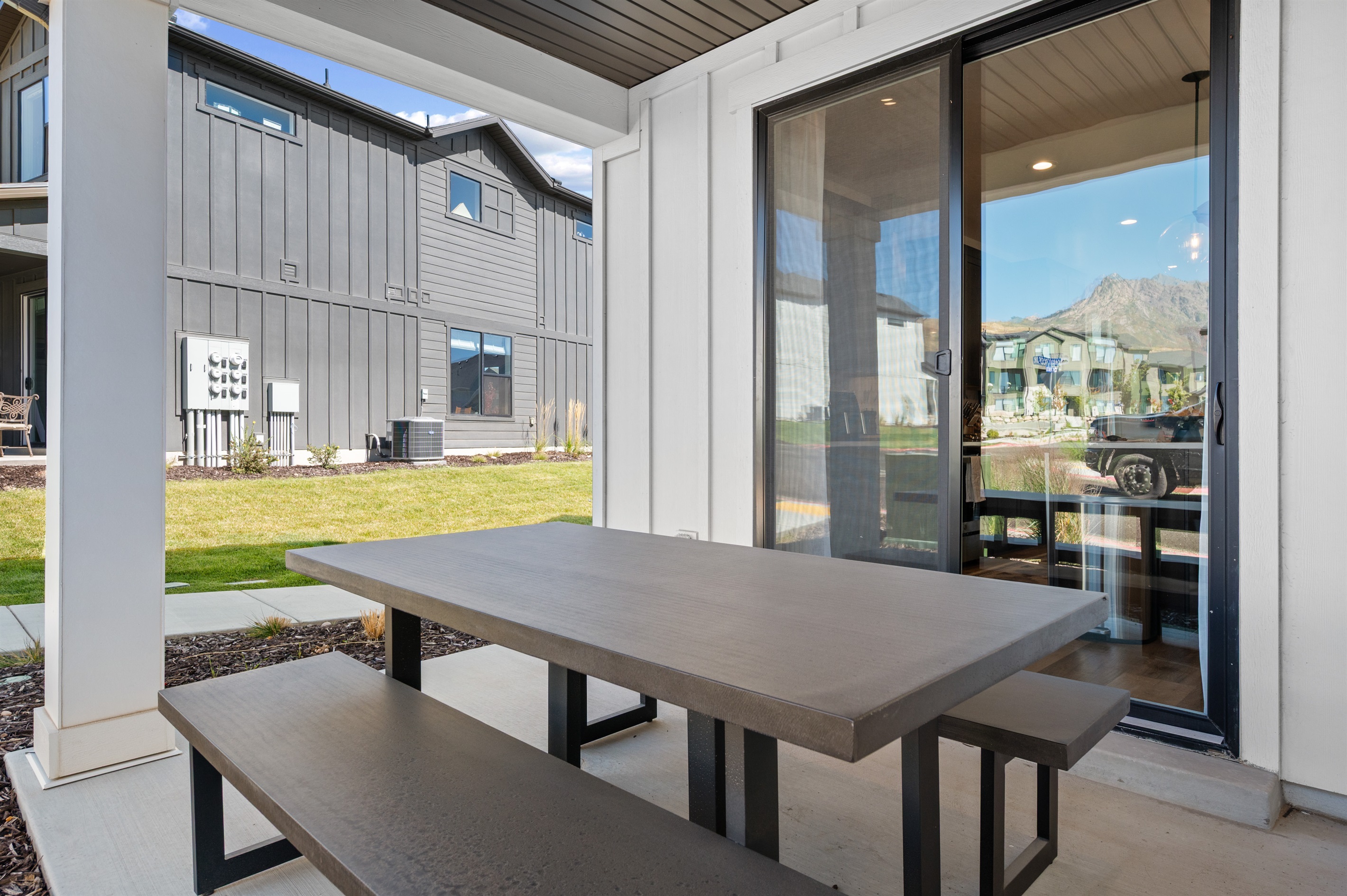 The covered patio is perfect for morning coffee or evening conversations.