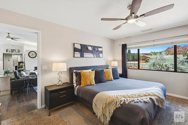 Master bedroom with king sized bed, with red rock views
