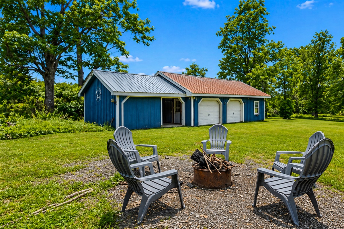 Gather around the fire pit for cozy evenings under the stars, surrounded by nature and a charming outdoor shed.