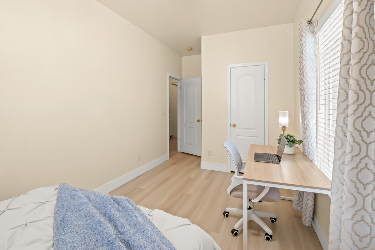 Need to catch up on work while traveling? This bedroom includes a dedicated workstation with a desk and chair, providing a comfortable space to work while enjoying natural light throughout the day.