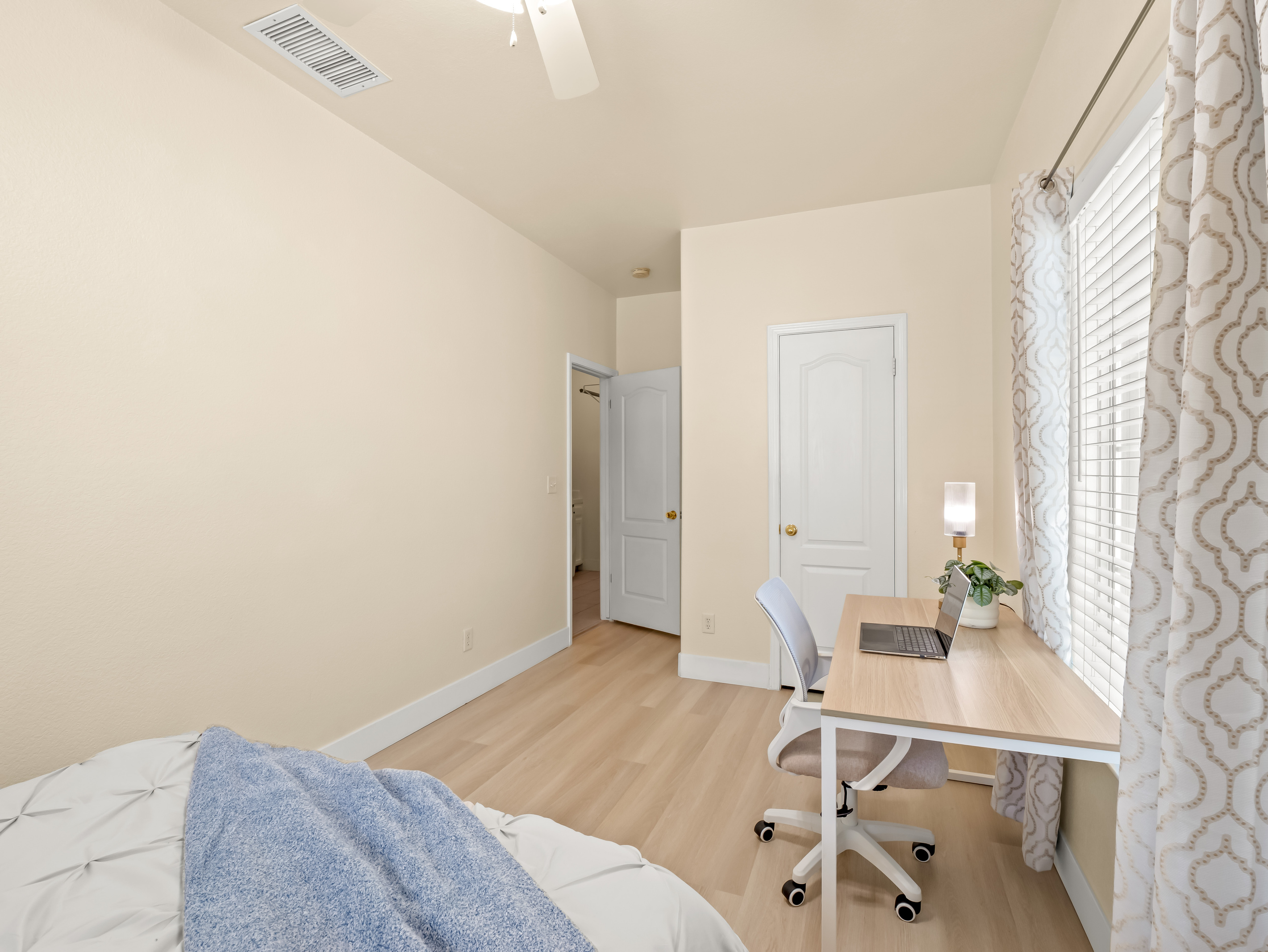 Need to catch up on work while traveling? This bedroom includes a dedicated workstation with a desk and chair, providing a comfortable space to work while enjoying natural light throughout the day.