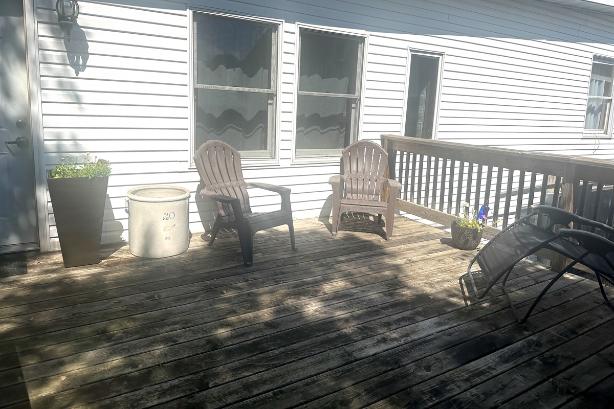 Catch the sunset from the attached deck through the neighboring trees.