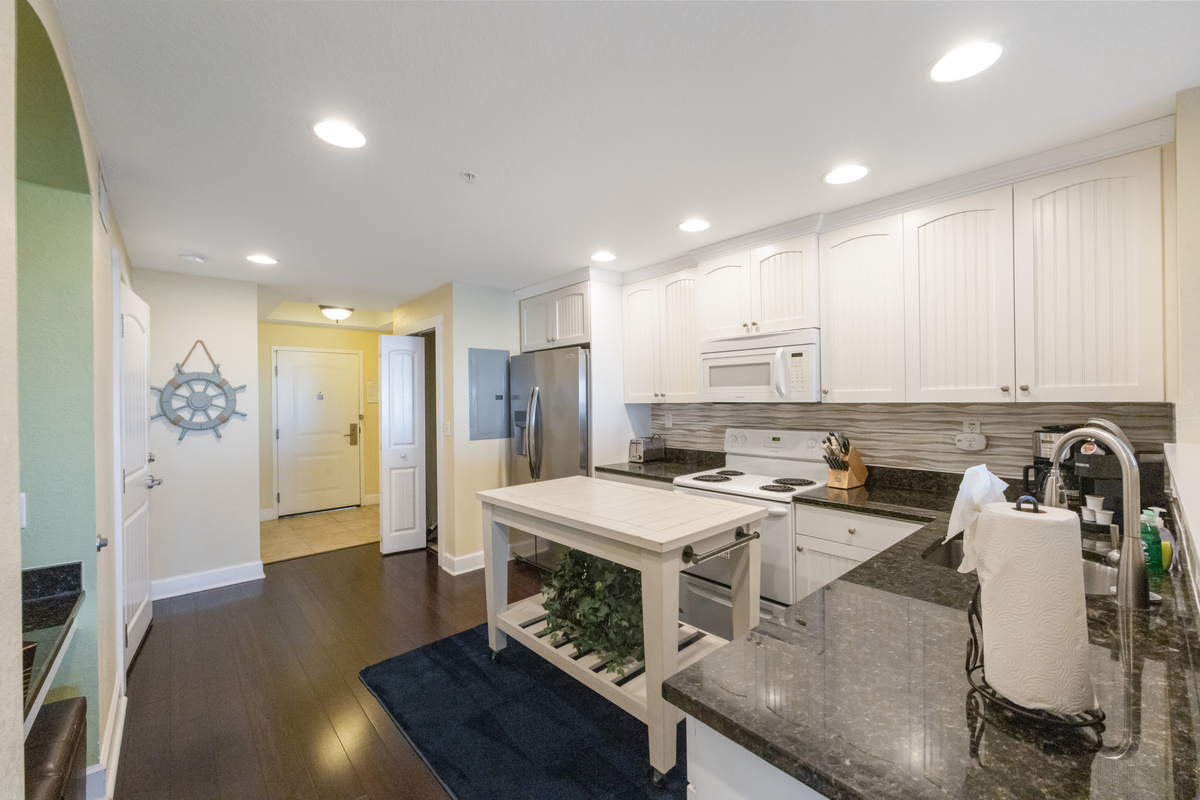 Kitchen - fully equipped w/ a microwave, dishwasher, full size fridge, Mr. Coffee, range, stackable washer/dryer, pots/pans, dishes and silverware.