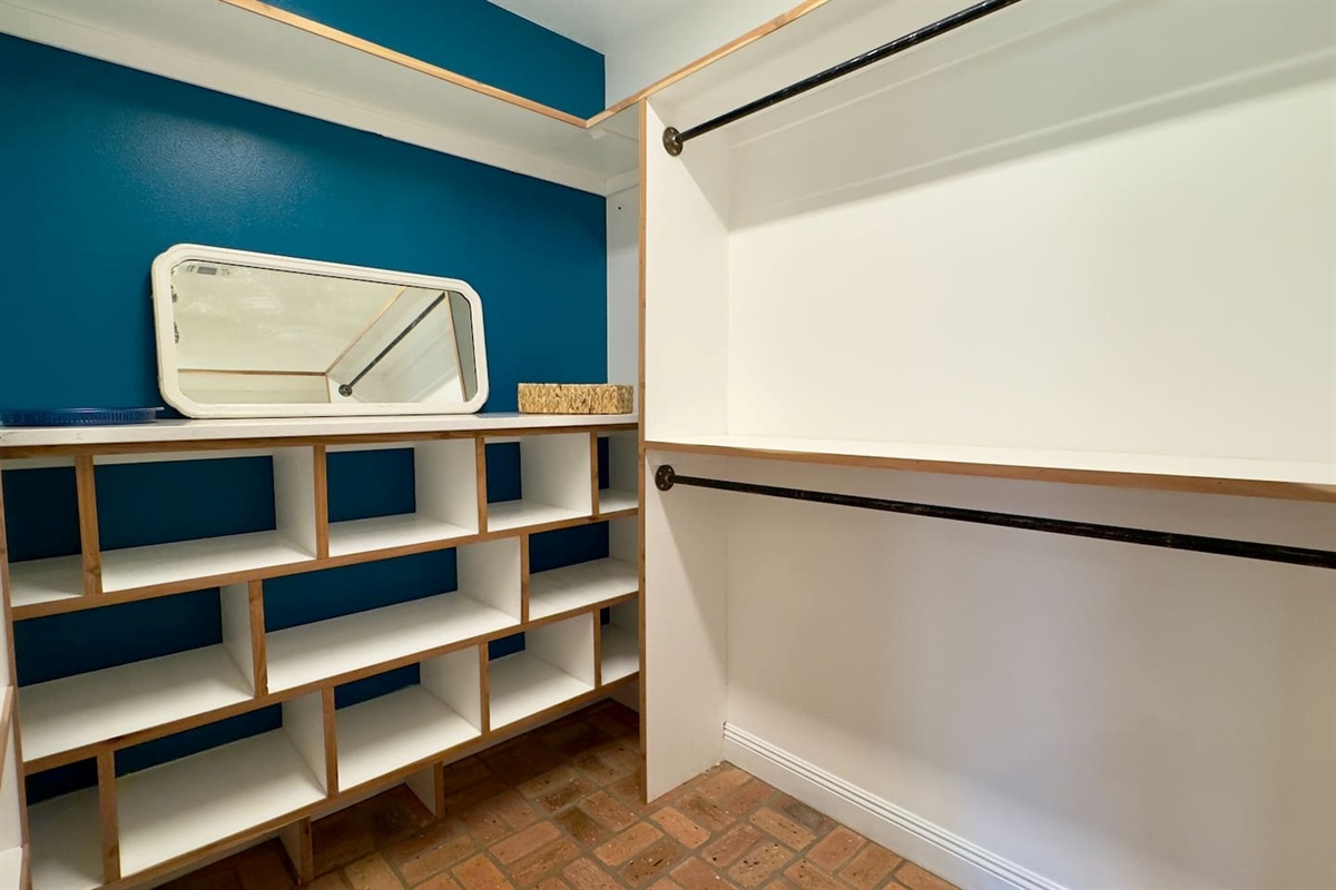 Built-in cubby shelves provide ample storage for shoes, accessories, and folded clothes.
