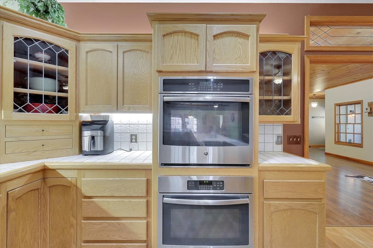 Kitchen wall ovens with nearby coffee maker, cabinet storage, and counter space for easy meals.
