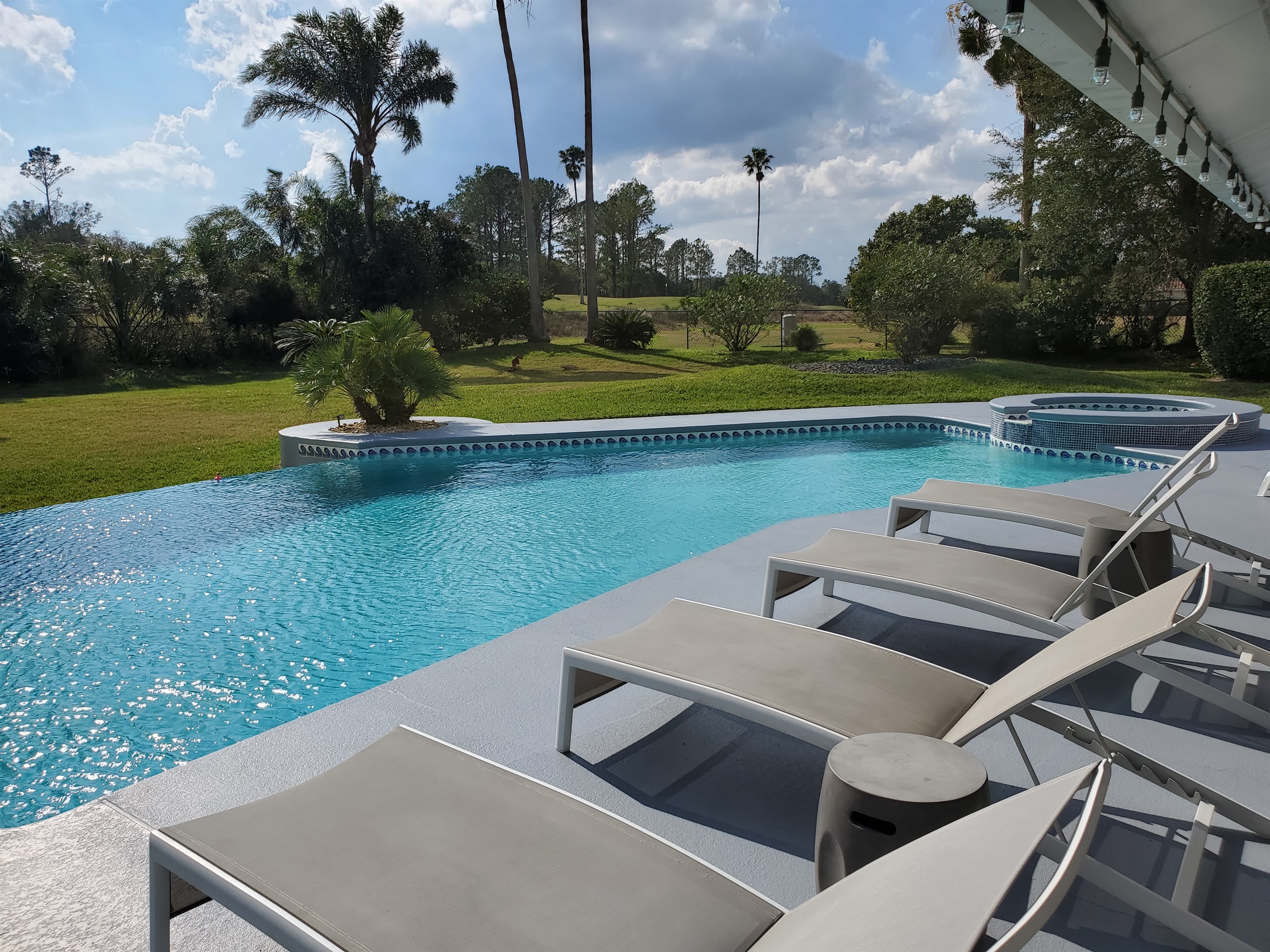 Sun Loungers, infinity edge pool and golf course view