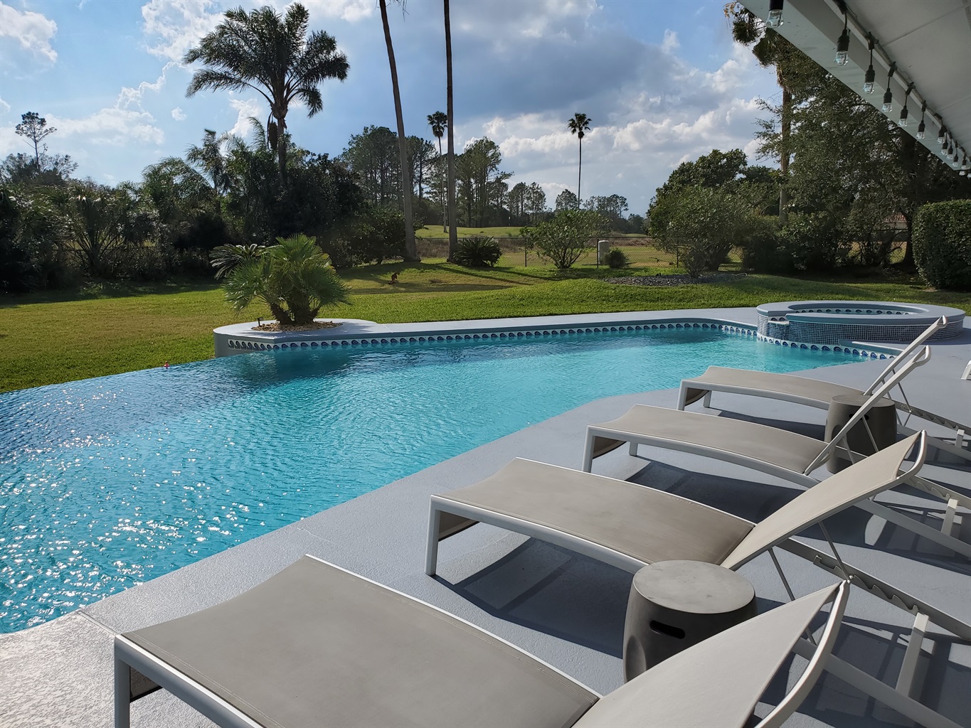 Sun Loungers, infinity edge pool and golf course view