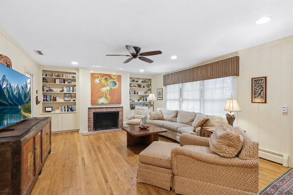 Spacious living room featuring a large smart TV & comfortable seating (please note, the fireplace is decorative only and not for guest use) 