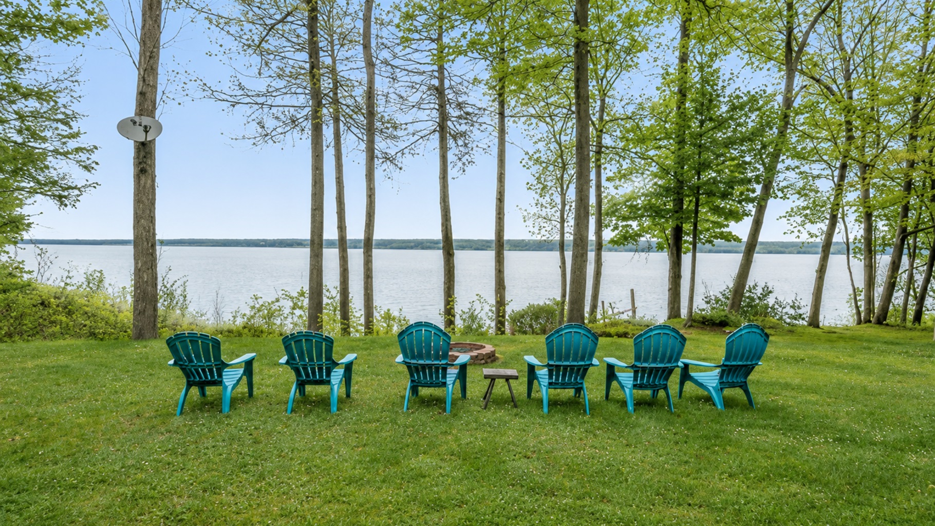 Unwind in Adirondack chairs with stunning lake views and serene forest surroundings 🌅🍃💺