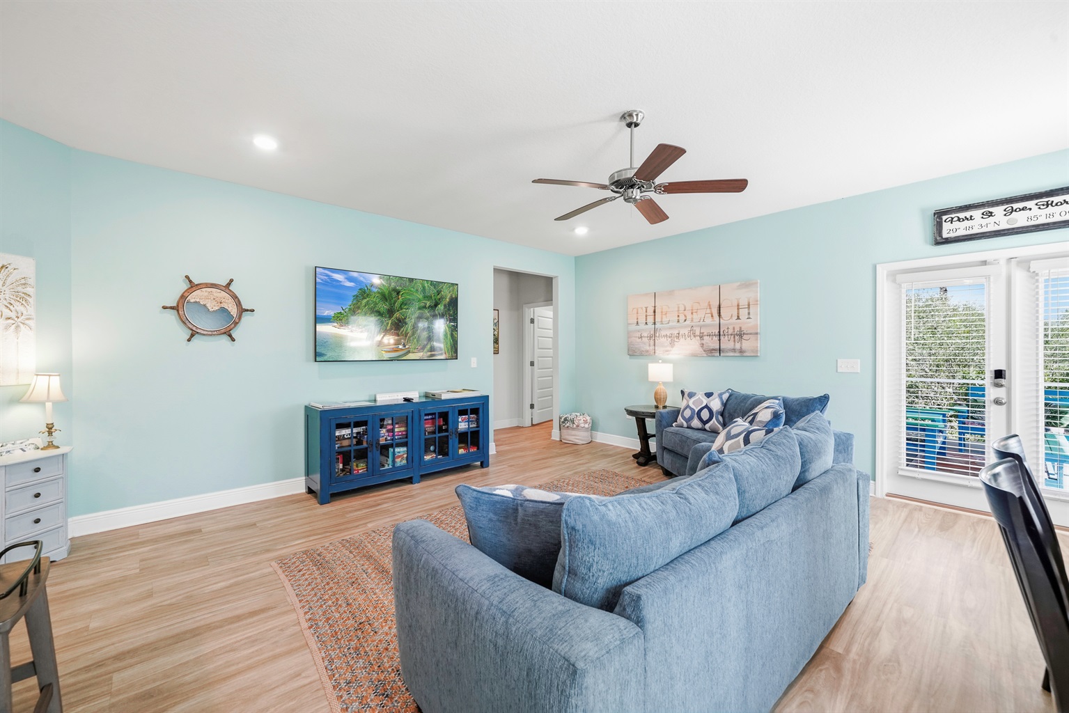 Relax in comfort with cozy seating, Smart TV, and a ceiling fan