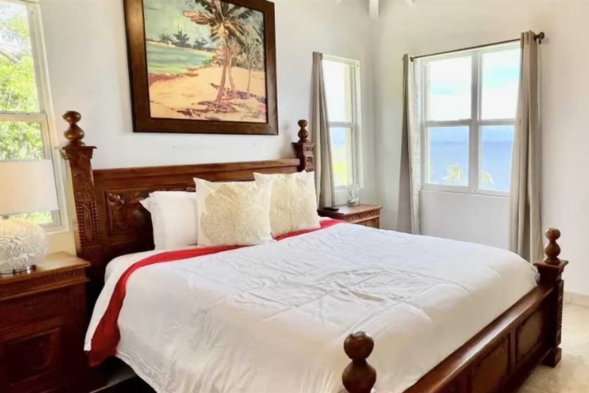 Comfortable king bed with plush pillows—your private space to unwind and recharge.