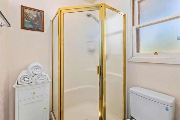 Fresh towels and a bright, clean shower make this upstairs bathroom a welcoming spot to refresh.