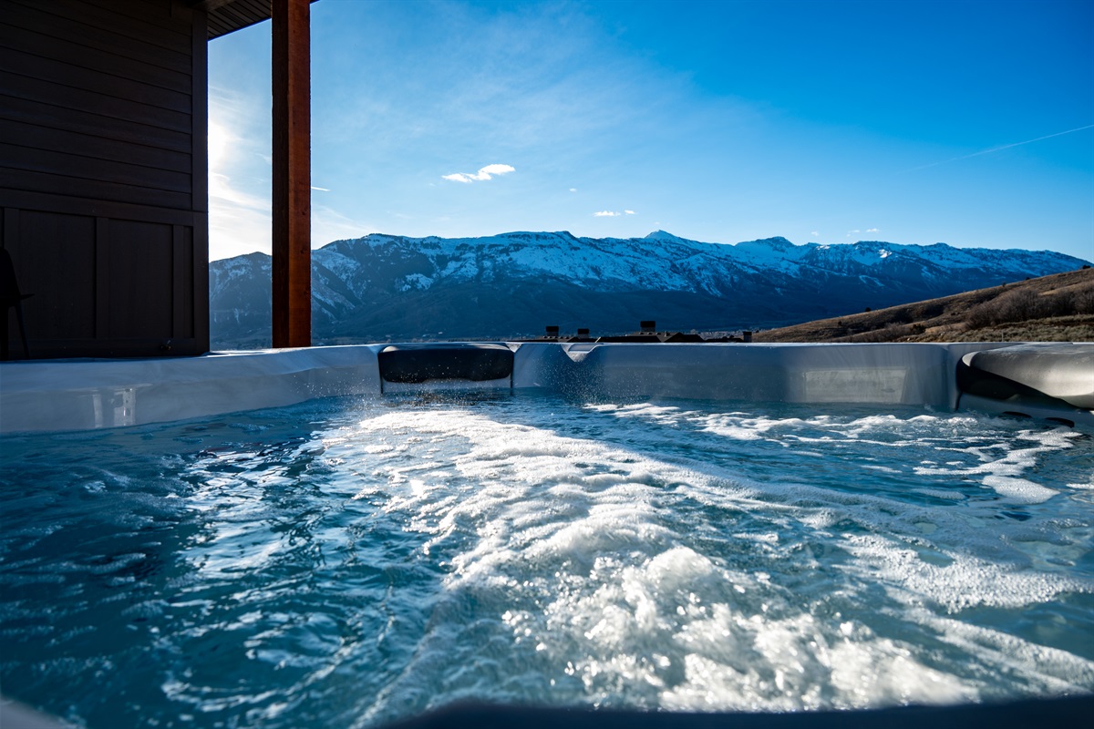 Private hot tub with breathtaking panoramic views of the Wasatch Mountains — perfect after a day at Powder Mountain or Snowbasin.