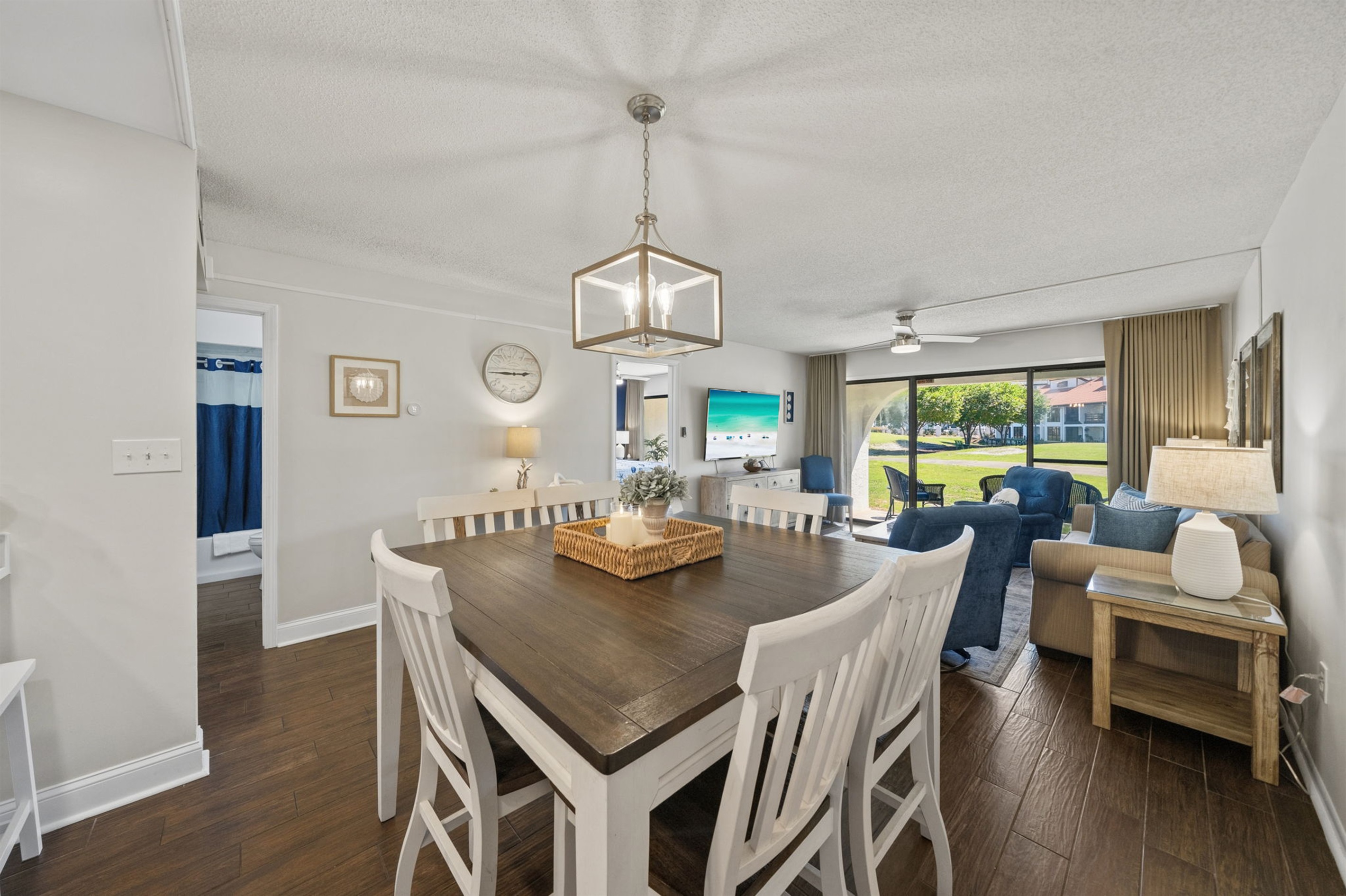 Open concept living space with plenty of seating for all and sliding glass doors to patio