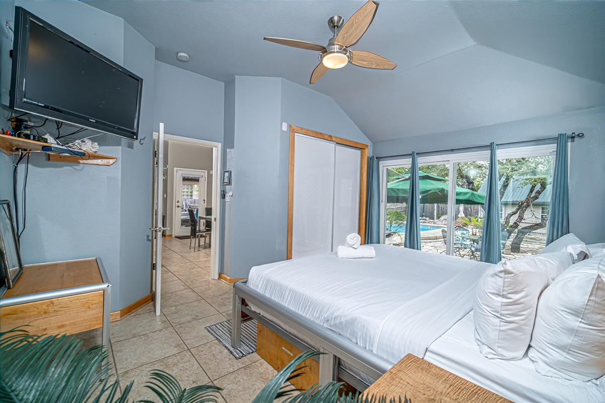 Master suite w custom king, dual zone, adjustable number bed w 2 remotes. View & access both pool & patio thru oversized, climate controlling sliding glass doors. Black-out drapes. Accent lighting, GFiber TV, ceiling fan in vaulted ceiling.