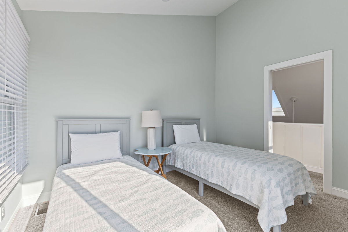 A bright and cheerful twin bedroom offers a comfortable space for kids, friends, or extra guests to settle in