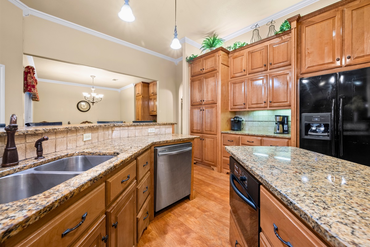 Gourmet kitchen with stainless appliances and double ovens.