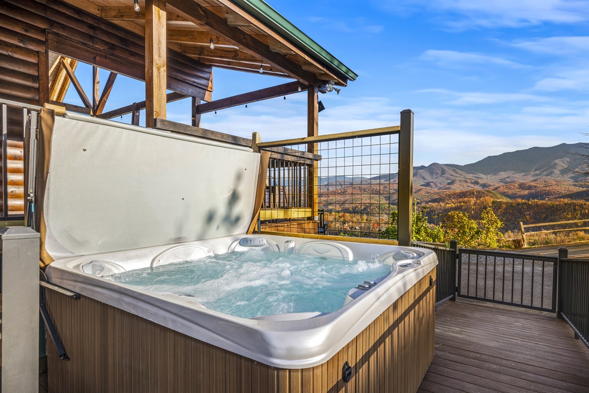 Relax and unwind in the hot tub at Signature Stay, offering the perfect way to enjoy the mountain views and soothe after a day of adventure