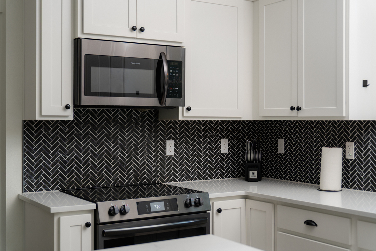 Cook a mountain breakfast on a full range, framed by striking herringbone tile.