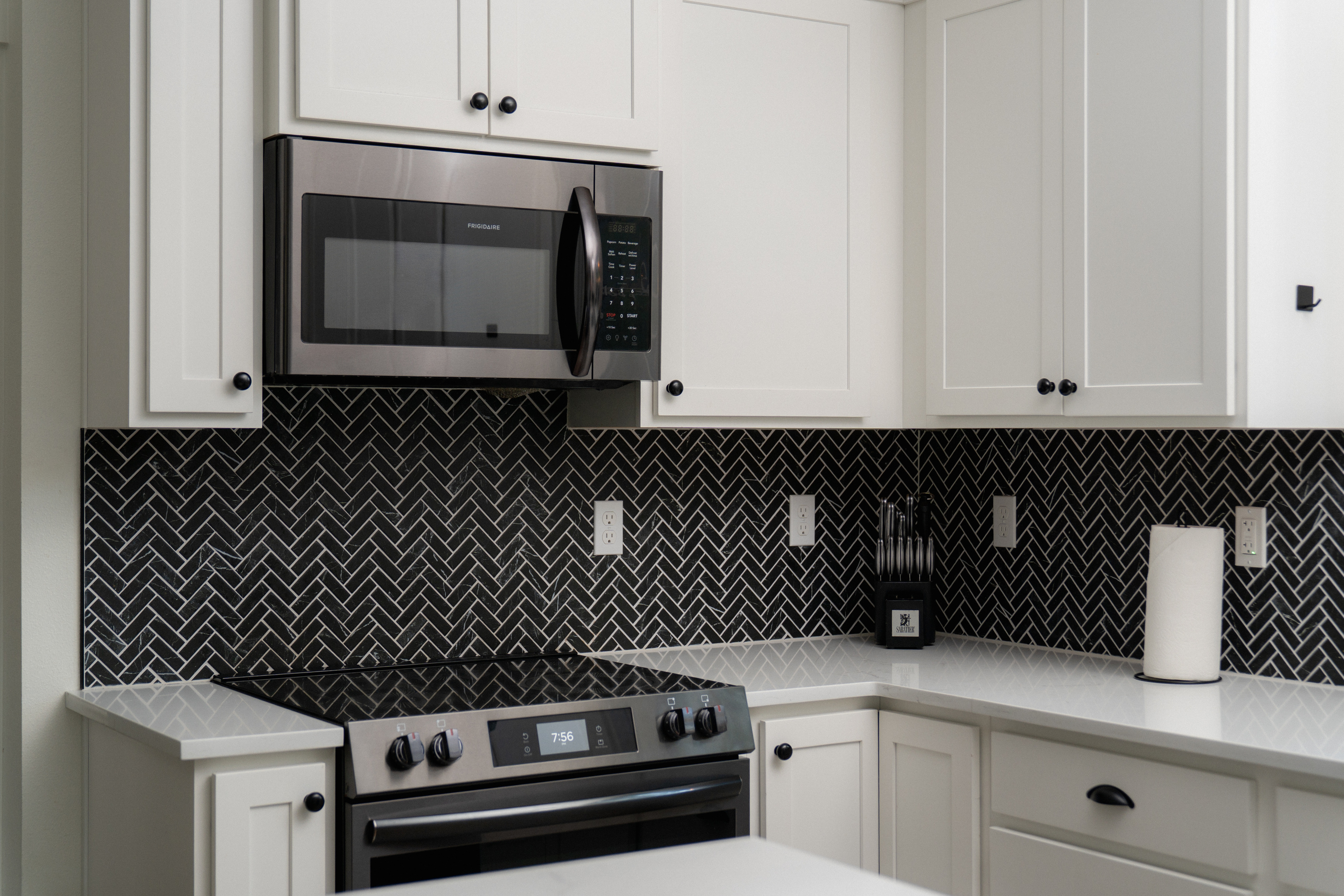 Cook a mountain breakfast on a full range, framed by striking herringbone tile.
