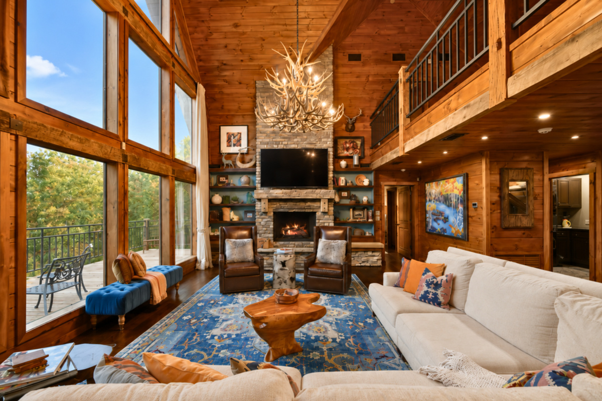 Unwind in a grand living room filled with natural light and cabin charm.