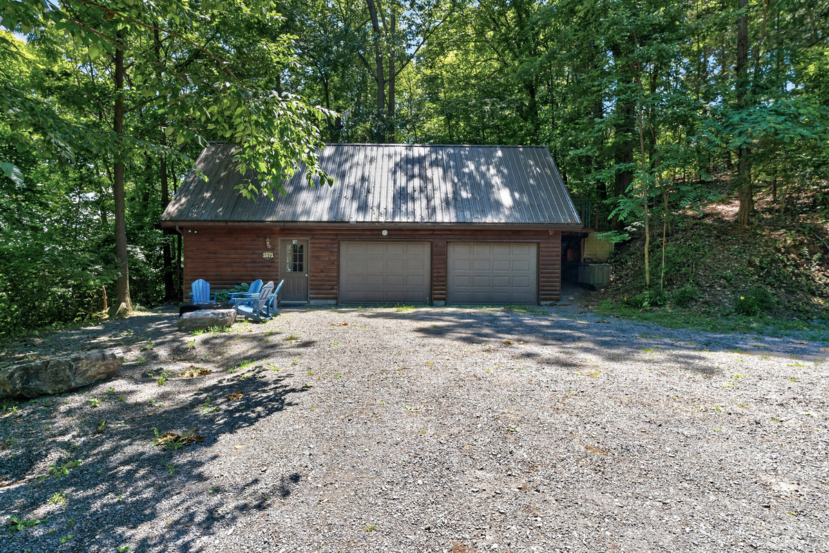 Gravel driveway facing garage