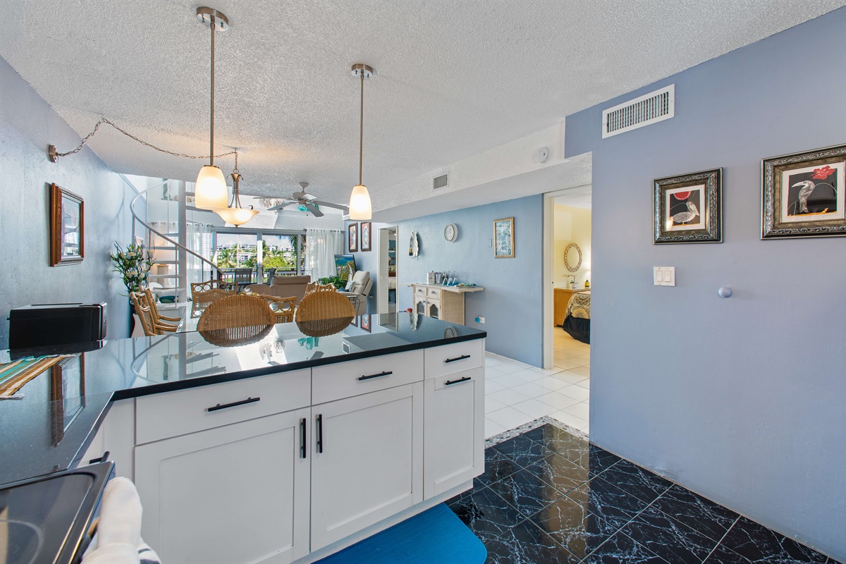 Open floor plan between the kitchen, dining, and living rooms