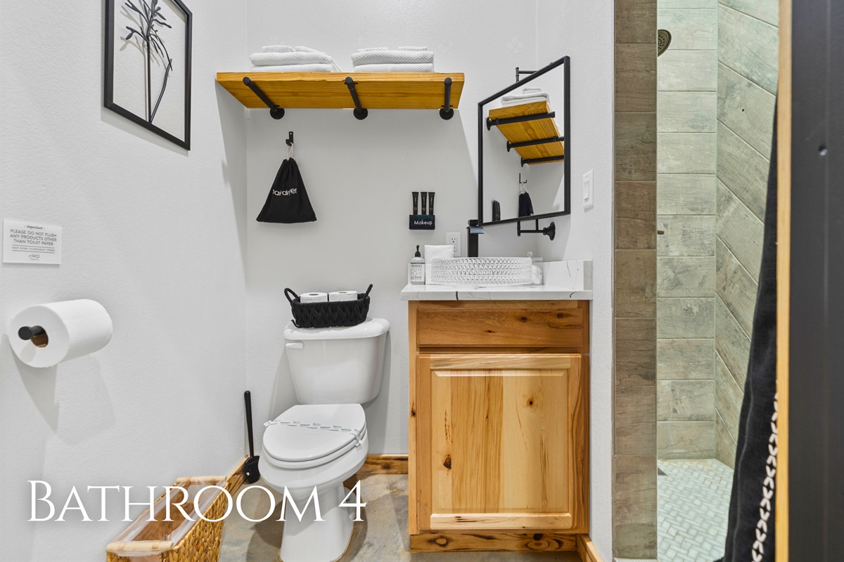 Bathroom 4 includes warm wood cabinetry and a beautifully finished shower, creating a spa-like feel.