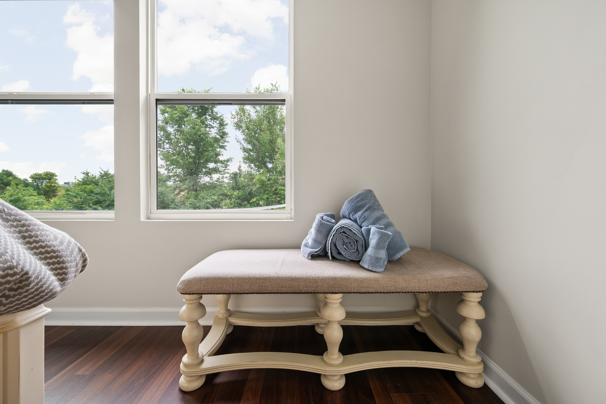 Designed with comfort in mind, Bedroom 2 offers a cozy retreat complete with a seating bench, perfect for getting ready for the day or unwinding before bed.