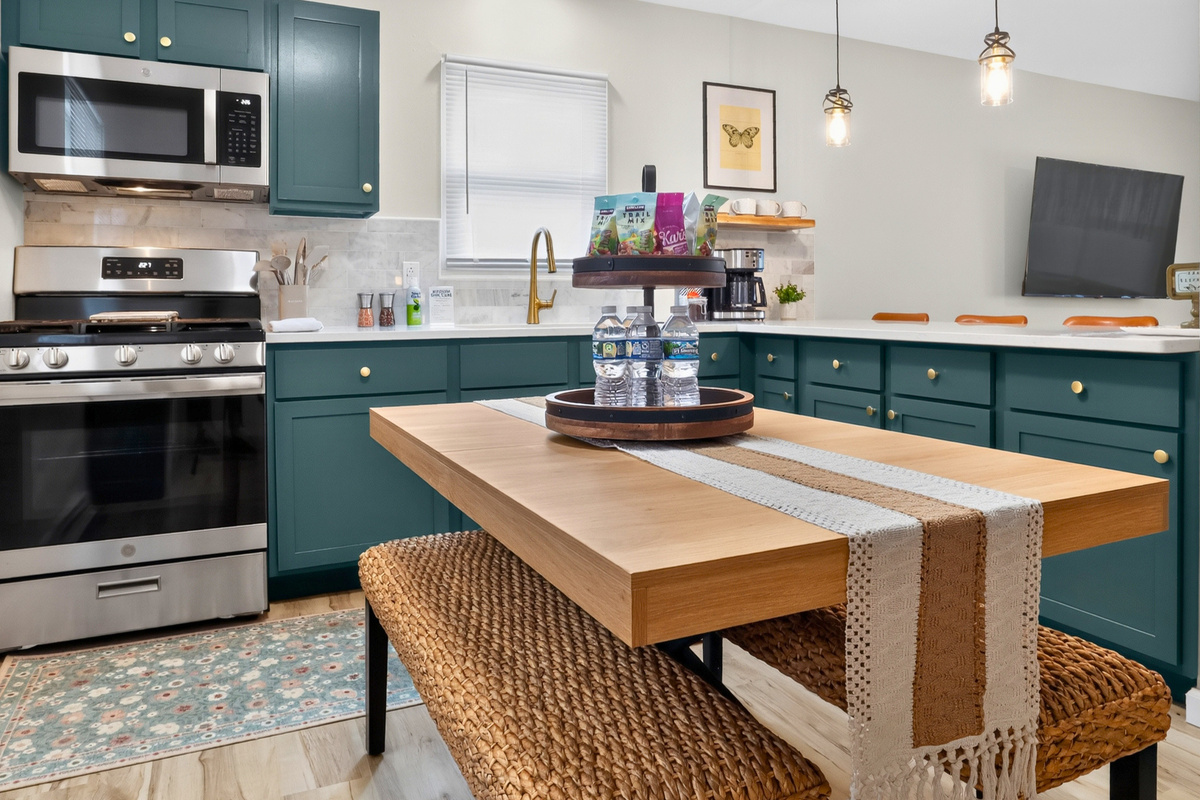 Beautiful stone finishes, stainless appliances, and island seating create a welcoming kitchen.