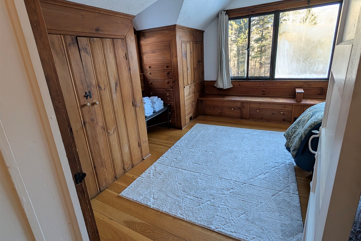 Rustic bedroom retreat featuring handcrafted wood details and peaceful natural light.