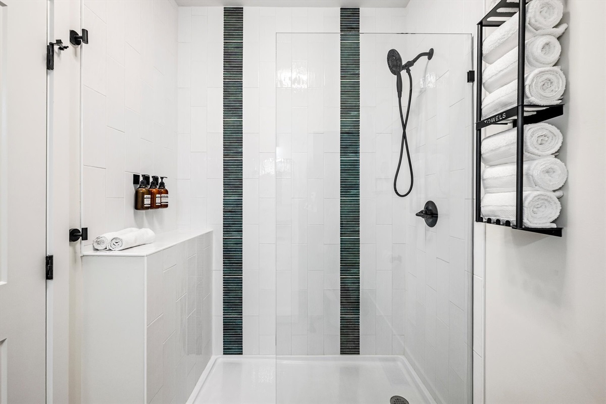 {Ensuite Bath} Step into a full walk-in shower — warm water, soft lighting, and a moment to reset after a full day.
