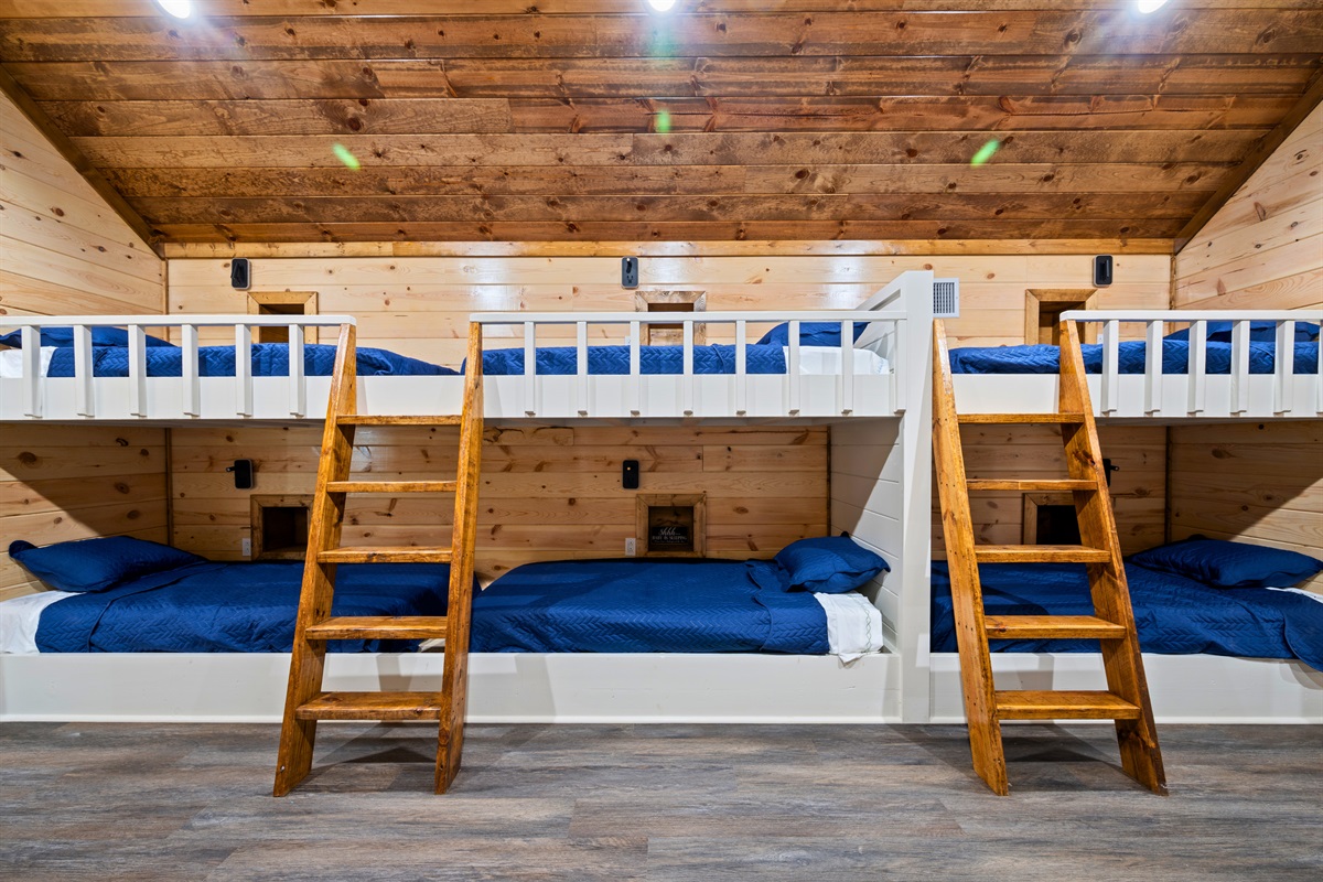 With sturdy ladders, cozy bedding, and several bunks lined up along the walls, the bunk room becomes a fun sleepover-style space that younger guests especially love.