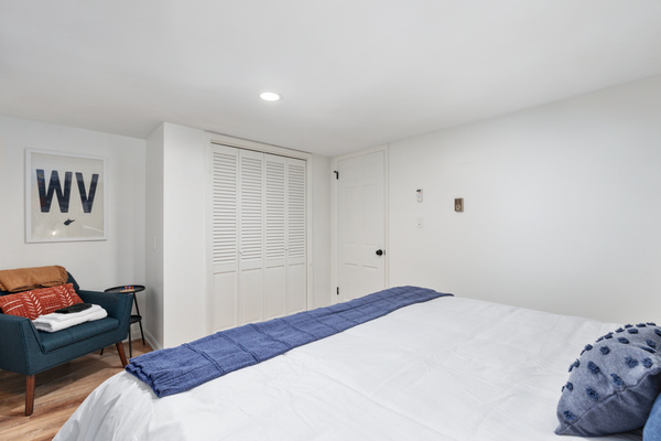 A king bed with all linens provided and a cozy sitting space to unwind with a good book — everything you need for a restful stay.