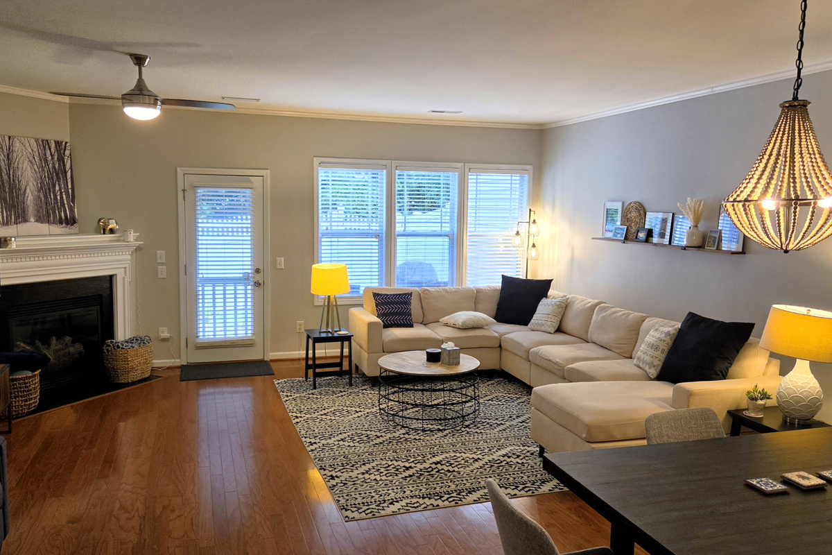 Living room with fireplace, backyard access, dining area