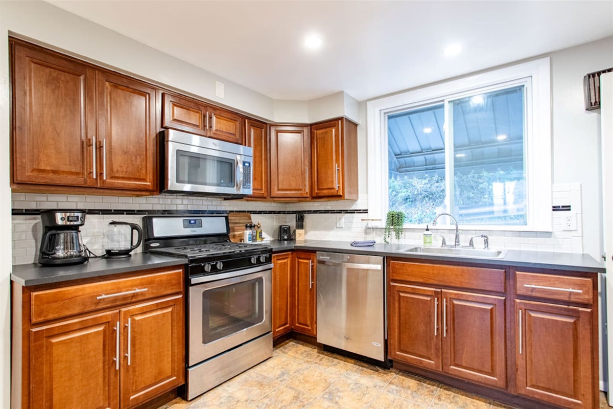 Fully equipped kitchen with modern appliances, including a stove, oven, refrigerator, microwave, and all the cookware and utensils you need to prepare your favorite meals.