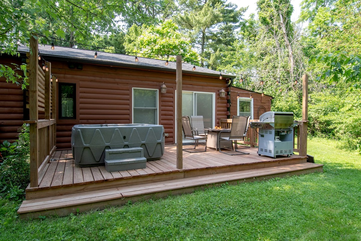 This is a great place to sit with a cup of coffee and listen to the birds and watch for deer and other wildlife. This deck is off the bedroom of the Guest Quarters. It has a 5 person hot tub, fire table and propane grill. 