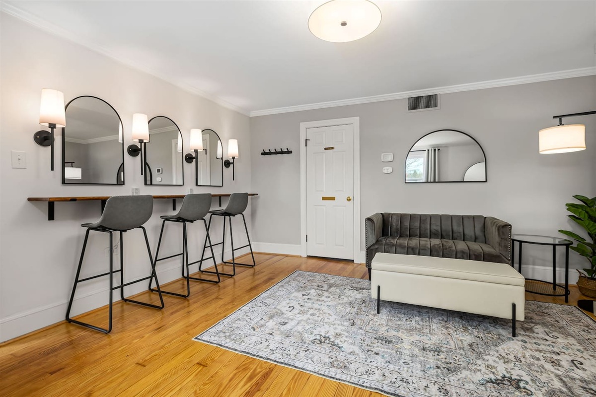 The getting ready room (also Bedroom #1)  includes a beauty bar for hair and makeup, small loveseat, full bathroom, oversized mirror, and a pull-down queen size Murphy bed.