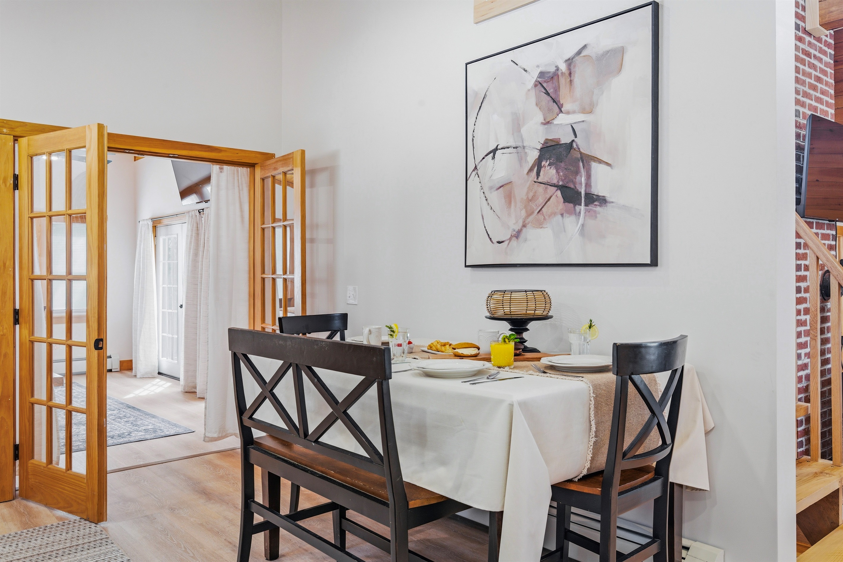 French doors and fresh air: our dining area offers a seamless flow between indoor comfort and mountain views.