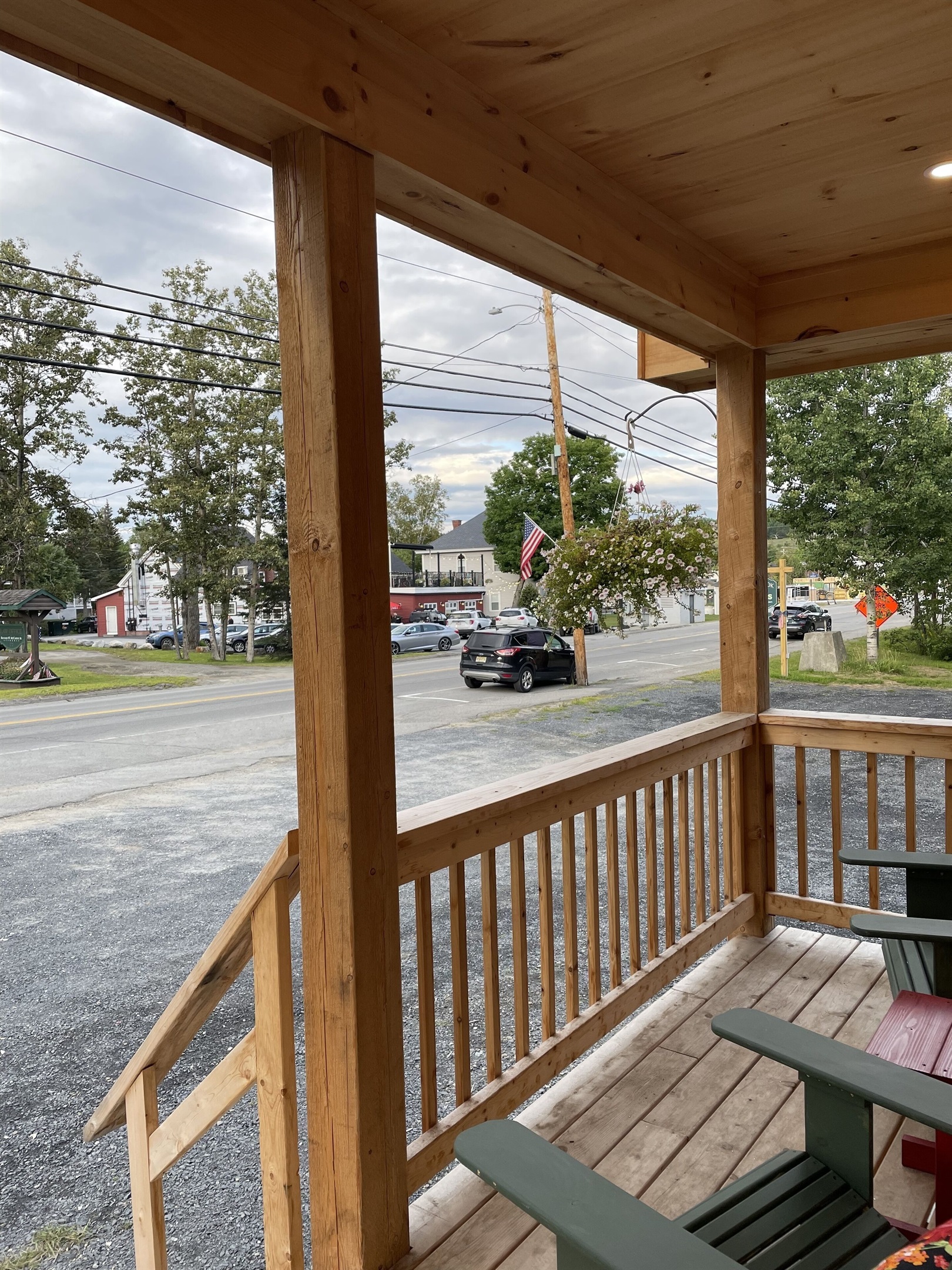 Front porch with Adirondack chairs with access to restaurants, shops, and lake!