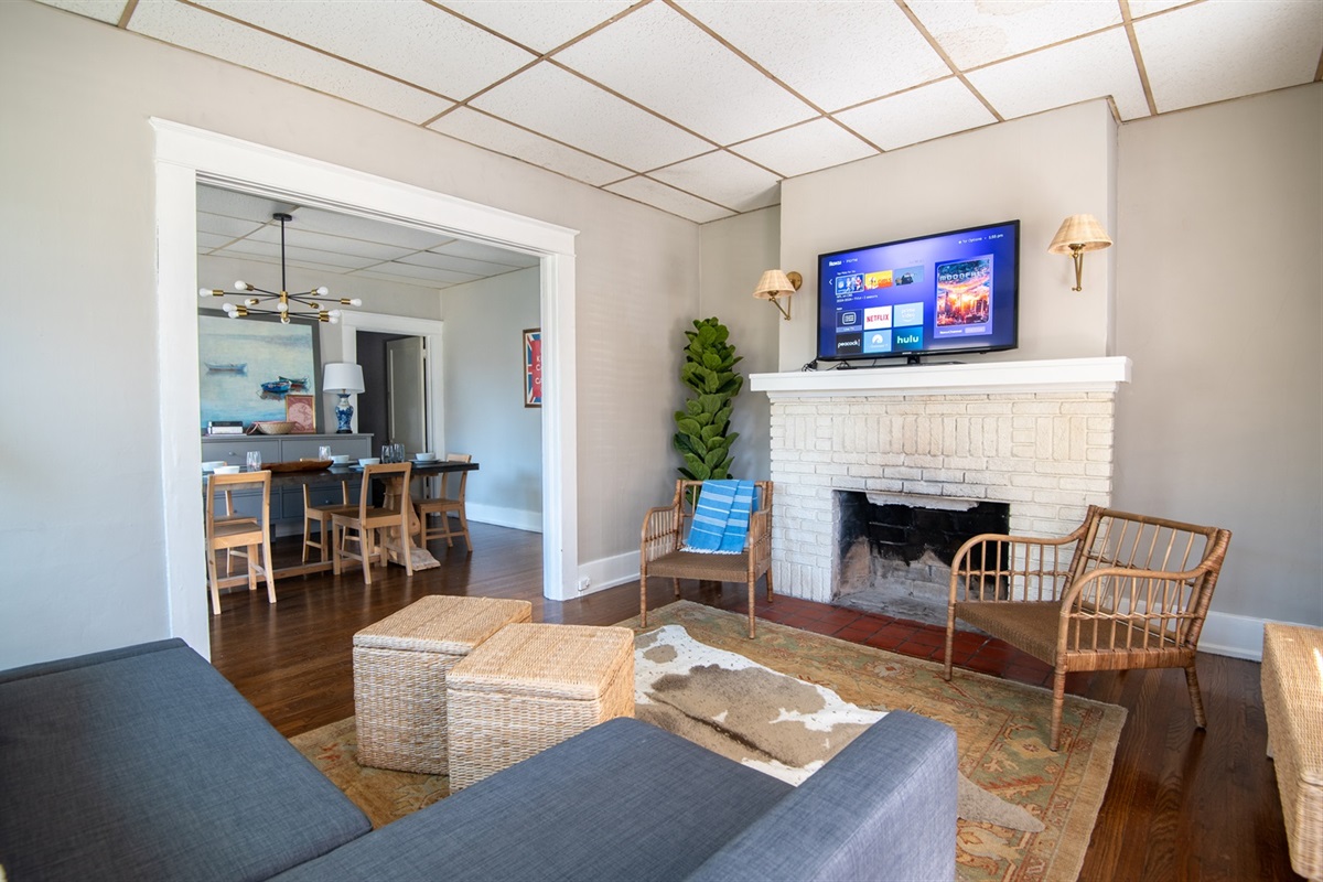 Cozy living area with smart TV and vibrant art pieces.