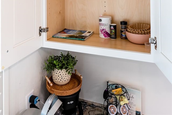 Open cabinets reveal pantry staples, cooking basics, and spices to make you feel right at home.

