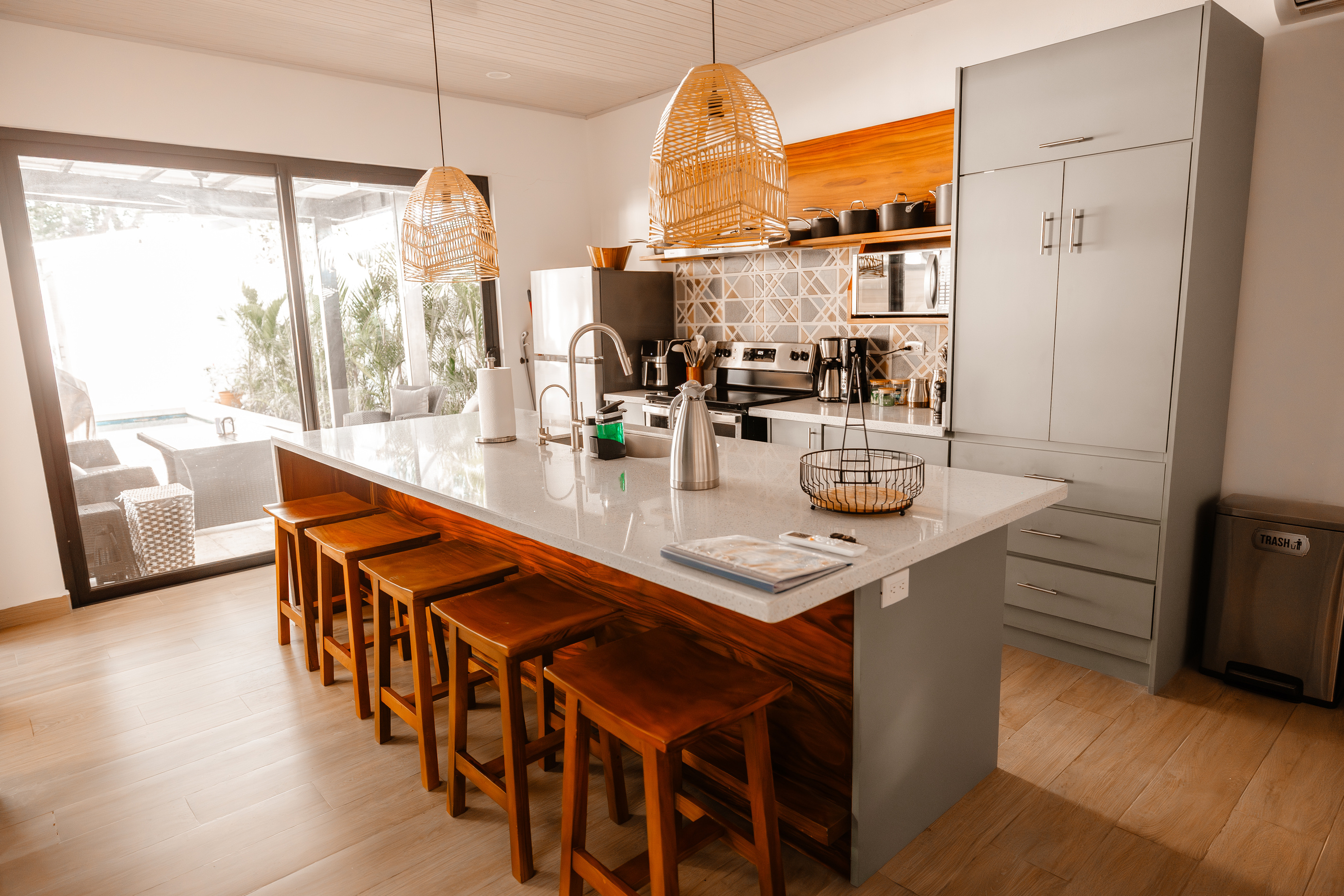 The kitchen opens onto the terrace. Pour a coffee, slide the doors, day starts.